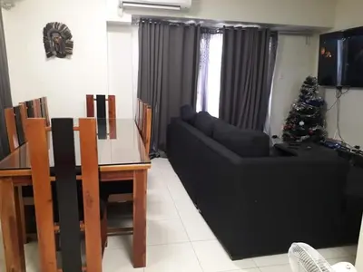 a living room with a christmas tree and a couch at Cucun's place in Manila