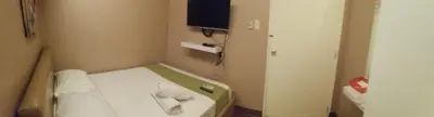 a small room with a bed with towels on it at ANNELENA INN in Manila