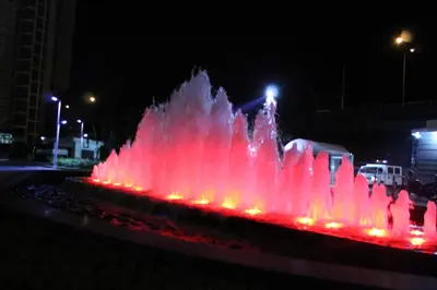 a water fountain at night with red lights at Azure C2 Balcony wifi Near Mall Airport MULTIPLE UNITS in Manila