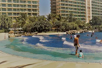 a man and a child in a wave pool at a resort at Azure C2 Balcony wifi Near Mall Airport MULTIPLE UNITS in Manila