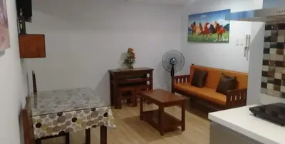 a living room with a couch and a table at Azure C2 Balcony wifi Near Mall Airport MULTIPLE UNITS in Manila