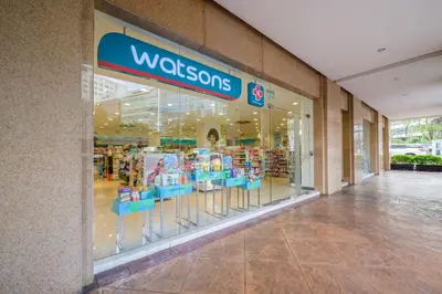 a wisdom store window with blue chairs in a mall at Modern Stylish Condo in Morgan Suites McKinley with Wi-Fi in Manila