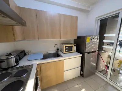 a small kitchen with a sink and a microwave at StayHere BGC City Studio in SOMA near SM Aura in Manila