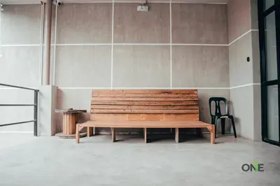 a wooden bench in a room with a wall at One Biñan Place in Biñan