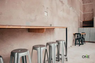 a group of stools in a room with a table at One Biñan Place in Biñan