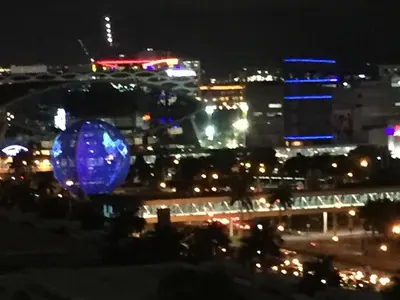a view of a city at night with a blue orb at A SPECIAL PLACE Shore Residences in Manila