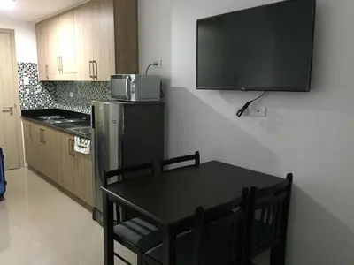 a kitchen with a table and a microwave on the wall at A SPECIAL PLACE Shore Residences in Manila