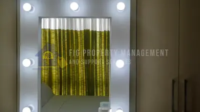 a mirror with a reflection of a yellow shower curtain at East Bay Residences @ Sucat Muntinglupa in Manila