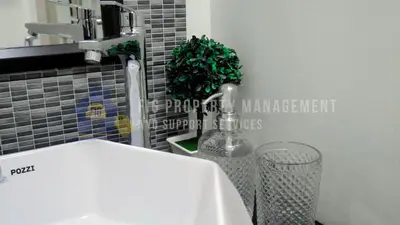a bathroom with a sink and a faucet at East Bay Residences @ Sucat Muntinglupa in Manila
