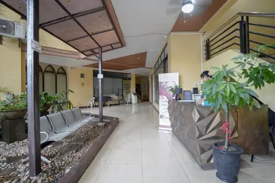 a lobby of a hospital with a waiting area with chairs at Arzo Hotel Grand Lodge in Manila