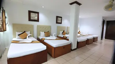 a room with four beds with swans on them at Loreland Farm Resort in Antipolo