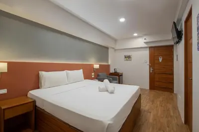 a bedroom with a large white bed in a room at iHotel Uptown BGC in Taguig