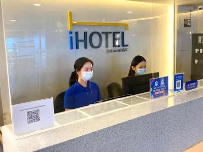 two women wearing face masks at an airport at iHotel Uptown BGC in Taguig