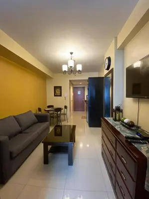 a living room with a couch and a table at Cozy Space at Shell Residences in Tower A in Manila