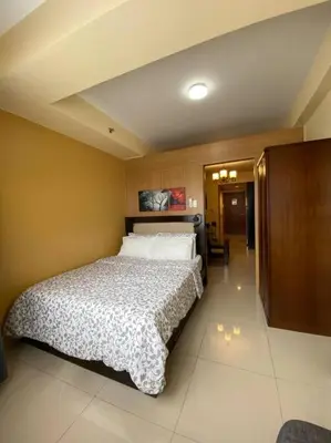 a bedroom with a large bed in a room at Cozy Space at Shell Residences in Tower A in Manila