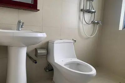 a bathroom with a toilet and a sink at Lucky Hotel Binondo in Manila