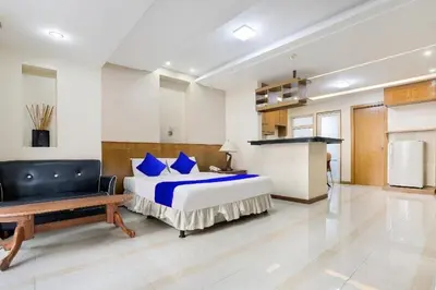 a bedroom with a bed and a couch in a room at Alley 8 Makati in Manila