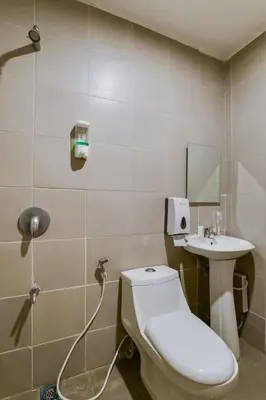 a bathroom with a toilet and a sink at OYO 473 Ranchotel Drive-in in Biñan