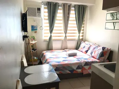 a small room with a bed and a window at Booker Com in Mandaluyong in Manila