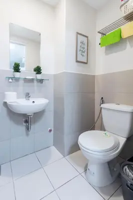 a bathroom with a toilet and a sink at 1BR Interiored Condo with WiFi, Netflix, Hot Shower - The Hive Residences in Taytay