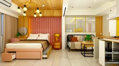 a bedroom with a bed and a living room at Manila Urban Resort at Azure in Manila
