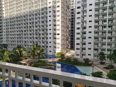 a view from the balcony of a building with tall buildings at Tower C Shore Residences by CSLUXE in Manila