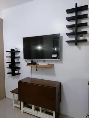 a flat screen tv hanging on a wall at Tower C Shore Residences by CSLUXE in Manila