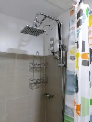 a shower in a bathroom with a shower curtain at Tower C Shore Residences by CSLUXE in Manila