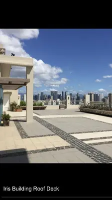 a building roof deck with a view of a city at Makati CBD Resort 2 bedroom in Manila