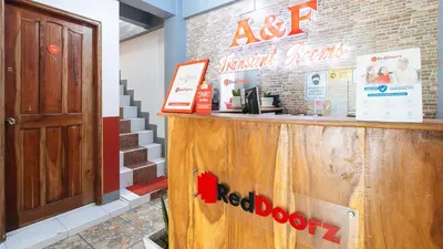 a bar in a restaurant with a red door at RedDoorz at A&F C5 Pinagsama Taguig in Manila