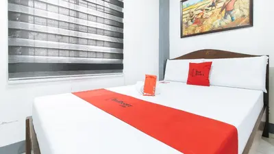 a bedroom with two beds with red pillows at RedDoorz at A&F C5 Pinagsama Taguig in Manila