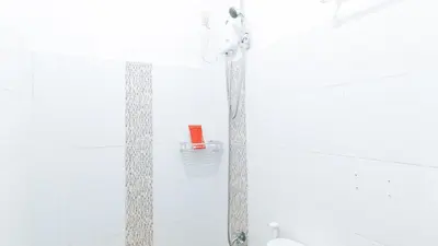 a shower in a bathroom with a red item on it at RedDoorz at A&F C5 Pinagsama Taguig in Manila