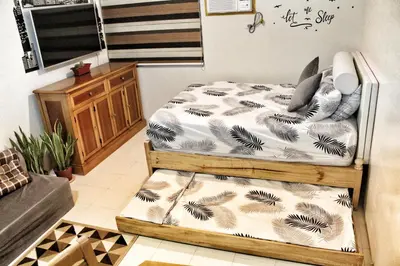 a bedroom with two twin beds in a room at CENTROPOLIS 1, Relax & Chill in Manila