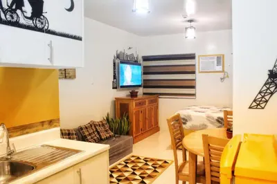 a kitchen and living room with a table and a dining room at CENTROPOLIS 1, Relax & Chill in Manila