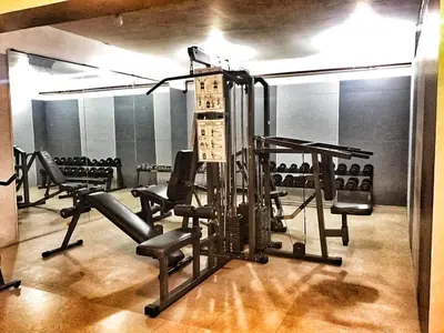 a gym with treadmills and chairs in a room at CENTROPOLIS 1, Relax & Chill in Manila