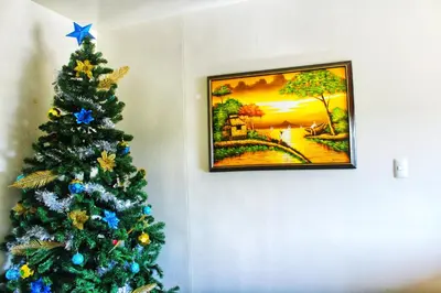 a christmas tree in a room with a picture at CENTROPOLIS 1, Relax & Chill in Manila