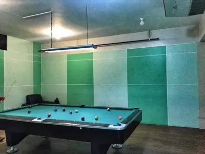 a pool table in a room with green walls at CENTROPOLIS 1, Relax & Chill in Manila