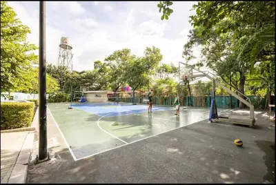 two people playing basketball on a basketball court at A Refreshing Condo Unit Near BGC, Ortigas & Makati with NETFLIX and WiFi in Manila