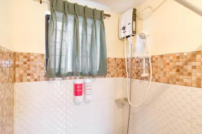 a bathroom with a shower with a shower curtain at RedDoorz Plus near Johnson and Johnson Paranaque in Manila