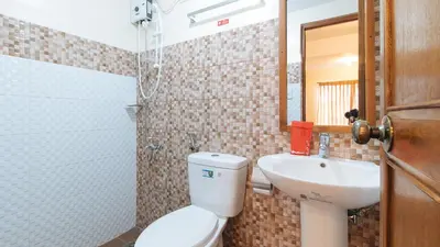 a bathroom with a toilet and a sink at RedDoorz Plus near Johnson and Johnson Paranaque in Manila