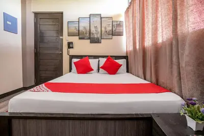a bedroom with a bed with red pillows at Rjat Guesthouse in Biñan