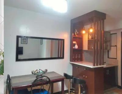 a dining room with a table and a mirror at Estien’s cozy condo to stay with kitchen in Manila