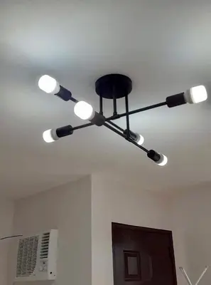 a ceiling light with six lights on a ceiling at Estien’s cozy condo to stay with kitchen in Manila