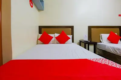 a bedroom with two beds with red pillows at OYO 431 Apollo 11 Apartelle in Manila