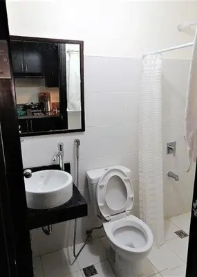 a bathroom with a toilet and a sink at Studio Condominium - Short and Long Term Staycation in Manila