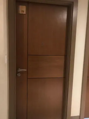 a wooden door with drawers in a room at Favila Condotel unit in Palmtree Villas Newport City walking distance to Airport terminal 3 Accessable to Airport terminal 1 &2 in Manila