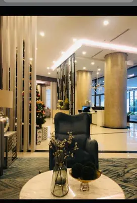 a lobby with a chair and a vase of flowers on a table at Madisons Crib at The Florence in Manila