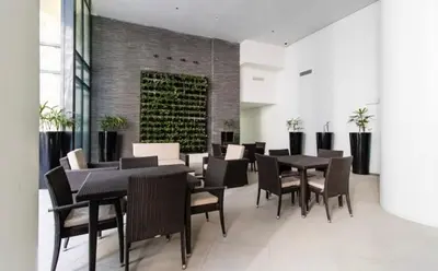 a dining room with black tables and chairs at Madisons Crib at The Florence in Manila