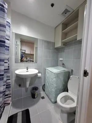 a bathroom with a toilet and a sink at King of kings at SEA RESIDENCES in Manila