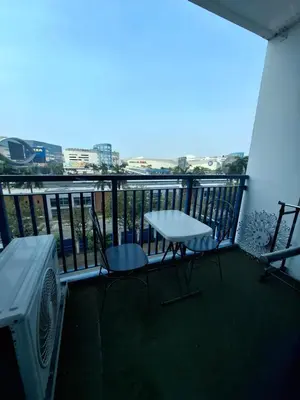 a balcony with a table and chairs and a view at King of kings at SEA RESIDENCES in Manila